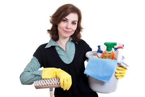 Professional using cleaning equipment with protective measures in place
